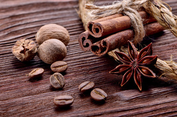 spices with grains of coffee on a wooden background