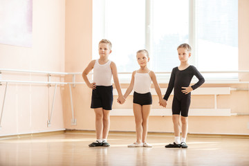 Fototapeta premium Young boys and a girl with posing at ballet dancing class