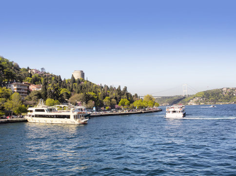 Cruise boats and famous landmark "Rumeli Hisari" in Istanbul