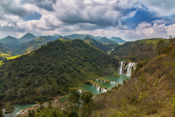 Fototapeta na wymiar Landscape of Yunnan with waterfall and mountains in forest