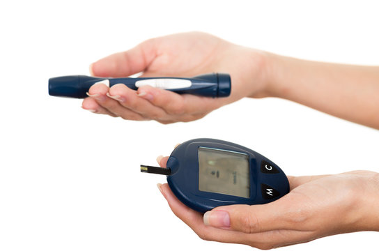 Hands holding glucose meter scanner pen and measure monitor in other hand with white background