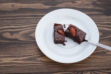 Homemade chocolate almond brownie were divided with a spoon