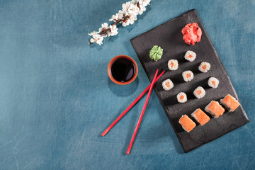sushi on plate with chopsticks, ginger, soy, wasabi and sakura