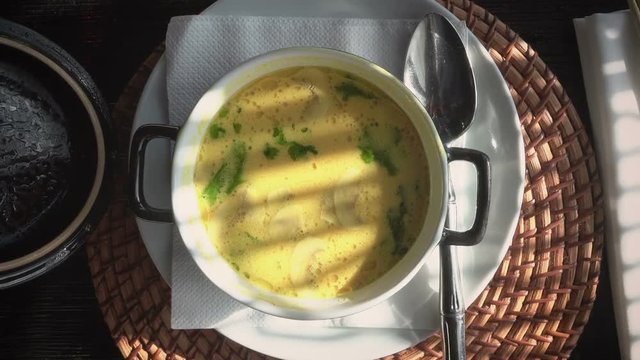 woman eats soup in a restaurant