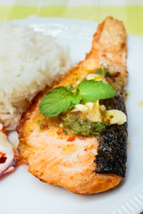 Rice and salmon steak with spicy sauce.