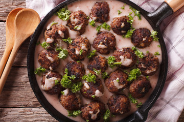 Swedish meatballs kottbullar with lingonberry sauce closeup. horizontal top view
