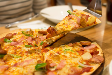 Serving a piece of pizza: Selective focus