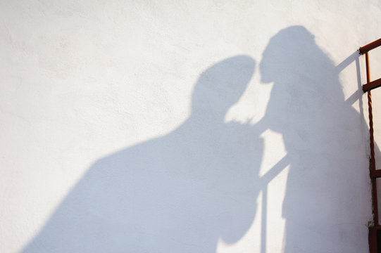 The Shadow Of The Bride And Groom On Wall