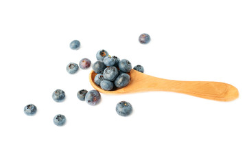 Wooden spoon filled of Bilberry or blueberry over isolated white background