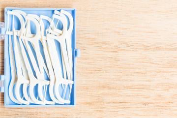 Oral Device : White dental flossers on wooden background