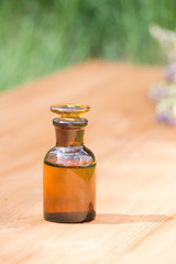 little brown bottle on booden board and grass