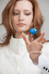 Woman scientist with atom model, research concept