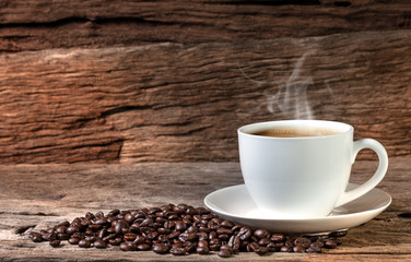 coffee mug and coffee breans on wood backgound