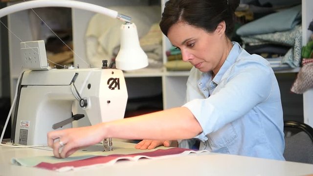 Portrait of seamstress working on sewing machine