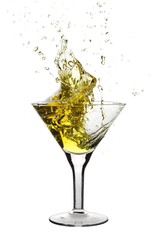 Martini being poured in a martini glass; isolated on a white background.