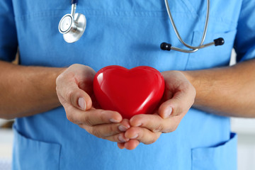 Male medicine doctor wearing blue uniform hold