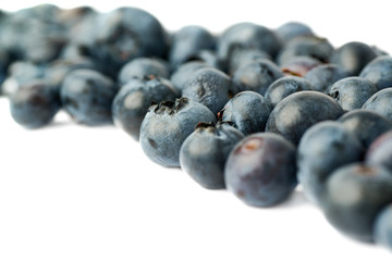 Bilberry or blueberry over isolated white background