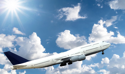 Airplane flying in the sky with beautiful sunlight.