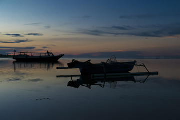 Fototapeta na wymiar Sunset with fisher boat and still water on Gili Air Island, Indo