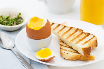 Soft boiled egg with toast for rich breakfast.