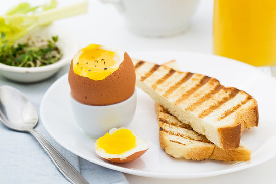 Soft boiled egg with toast for rich breakfast.