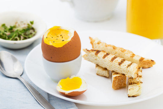 Soft boiled egg with toast for rich breakfast.