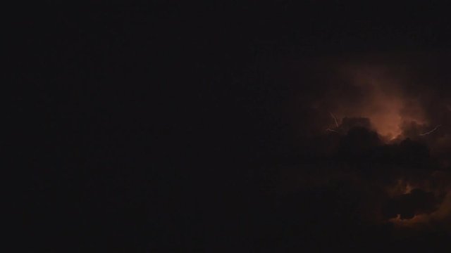 Line discharges and lightning against a background of storm clouds night