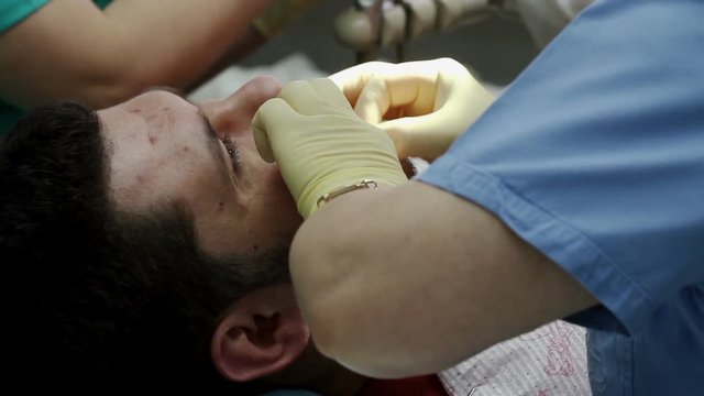 Treatment of caries. Man visits the dentist.