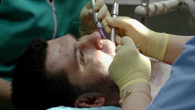 Treatment of caries. Man visits the dentist.