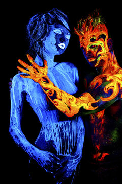 Body art glowing in ultraviolet light, four elements