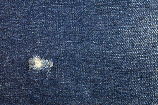 Blue torn denim jeans texture, Jeans background.