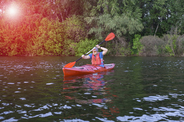 Travel on the river in a kayak on a sunny day.