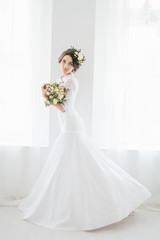 Beautiful happy young bride waiting for groom.