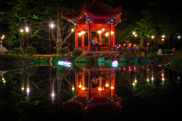 Chinese pavilion in Lazienki Krolewskie Park in Warsaw at night - 109371111