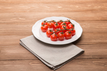 Fresh cherry tomatoes on white plate