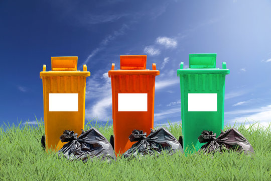 recycle bins and bag garbage on green grass  background ,ecology