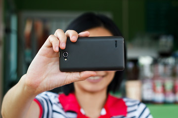 Hands touching smartphone bright background, closeup
