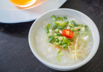 rice congee on wood table, thai breakfast
