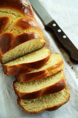 Braided challah bread shaped rectangular and cut in pieces 