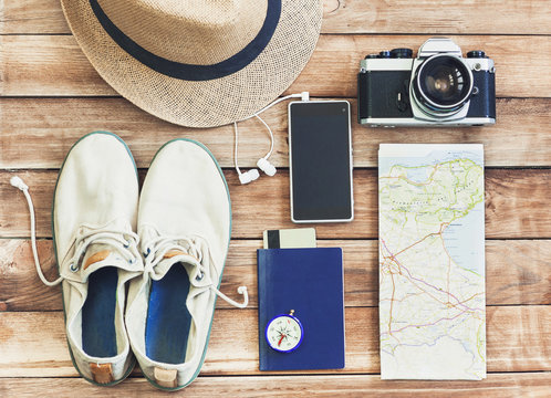 Accessories for travel. Passport, photo camera, smart phone and travel map. Holidays and tourism concept