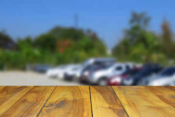 blurred image wood table and abstract the car parking.