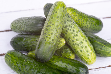 green cucumber on old boards