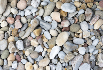 Background image of multi coloured pebbles on a beach 
