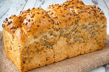 Fresh bread with sunflower seeds on burlap