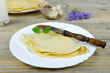 Folded pancake, chocolate spread and milk