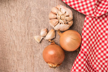 Fresh vegetables from the garden, garlic and onions on a wooden