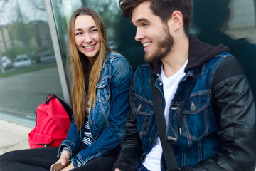 Obraz premium Two students talking in the street after class.