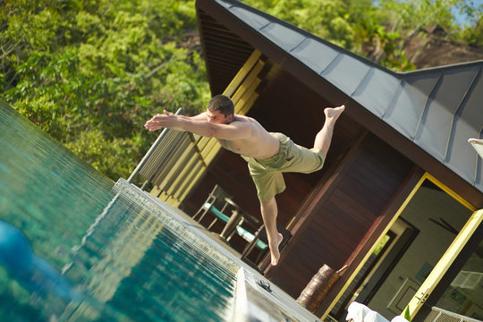 Handsome Young Lifeguard Plunge In Swimming Pool To Rescue.