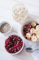 Healthy breakfast. Oatmeal with bananas, cranberries and sunflow