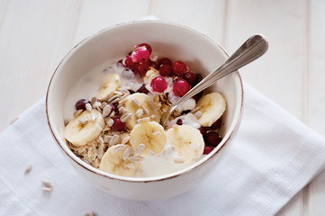 Healthy breakfast. Oatmeal with bananas, cranberries and sunflow